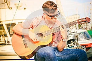 Trendy guy with guitar outdoor