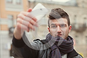 Trendy guy taking a selfie