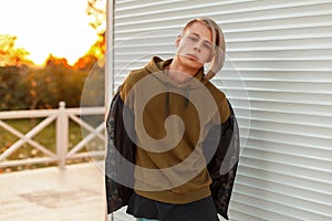 Trendy handsome young man with hair in a fashionable military