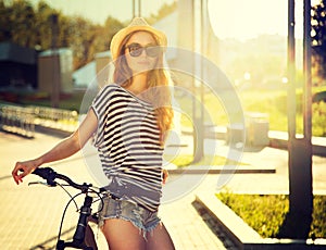 Trendy Hipster Girl with Bike in the City