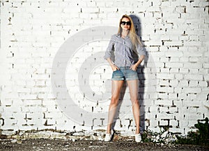 Trendy Hipster Girl at the Brick Wall