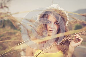 Trendy Hipster Girl in the hat Relaxing on the road at the day t