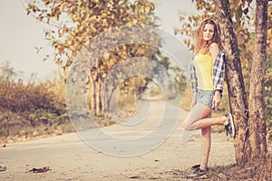 Trendy Hipster Girl Relaxing on the road at the day time.