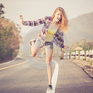 Trendy Hipster Girl Relaxing on the road at the day time.