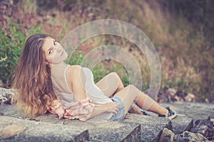 Trendy Hipster Girl Relaxing on the road at the day time.