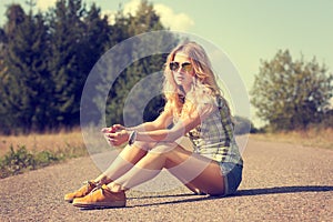 Trendy Hipster Girl Sitting on the Road