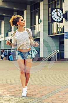 Trendy Hipster Girl on Urban Background.