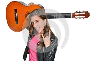 Trendy hispanic teenage girl carrying a guitar