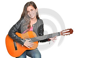 Trendy hispanic teenage girl playing an acoustic guitar