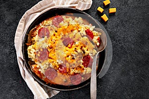 Trendy hybrid food. Mac and cheese pizza on dark background