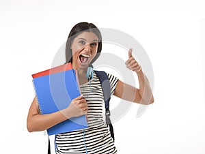 Trendy latin student girl holding notepad folder and book carrying backpack smiling happy