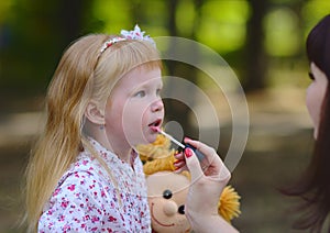 Trendy little girl in the summer park