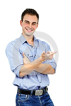 Trendy man in bluek shirt and jeans pointing something, portrait