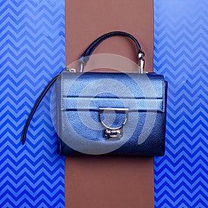 Trendy metallic blue leather women's handbag with silver metal clasp, top handle
