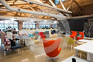 Trendy modern open concept loft office space with big windows, natural light and a layout to encourage collaboration