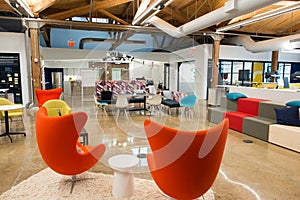 Trendy modern open concept loft office space with big windows, natural light and a layout to encourage collaboration