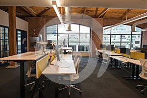Trendy modern open concept loft office space with big windows, natural light and a layout to encourage collaboration