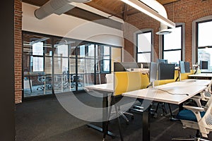 Trendy modern open concept loft office space with big windows, natural light and a layout to encourage collaboration