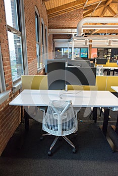 Trendy modern open concept loft office space with big windows, natural light and a layout to encourage collaboration