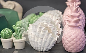 Trendy pastel color exotic pineapple, shell and cactus shaped ceramic vases, Arte Deco style home decor, selective focus photo