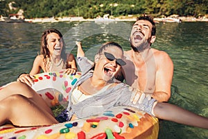 Trendy people having fun swimming in summer vacation