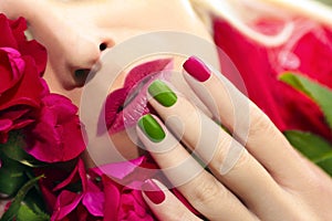 Trendy red green blue manicure and makeup.