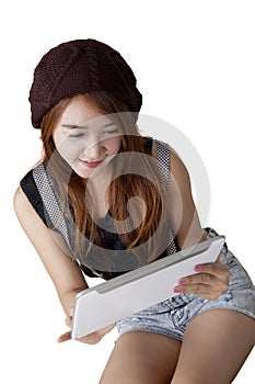 Trendy teenage girl using digital tablet