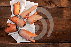 Trendy ugly organic carrot from home garden bed on barn wood table, Australian grown. Color-toning effect applied