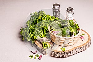 Trendy ugly organic cucumbers in a basket, garlic cloves, parsley greens, mustard, spices