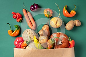 Trendy ugly organic vegetables. Assortment of fresh eggplant, onion, carrot, zucchini, potatoes, pumpkin, pepper in craft paper