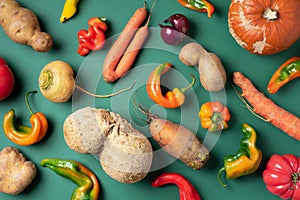 Trendy ugly organic vegetables. Assortment of fresh eggplant, onion, carrot, zucchini, potatoes, pumpkin, pepper in craft paper