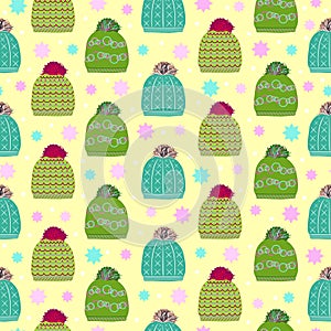 Trendy winter head hats knitted seamless pattern on light green background. Web, wrapping paper, textile or wallpaper