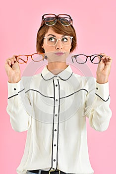 Trendy woman choosing eyeglasses isolated