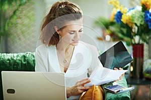 Trendy woman with documents and calculator choosing insurance