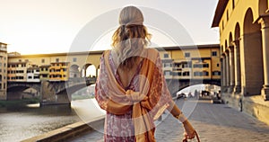 A Trendy Woman\'s Sunrise Saunter Near Florence\'s Old Bridge