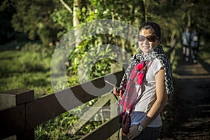 Trendy woman with scarf and handphone gimbal stabilizer near ranch