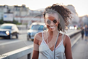 Trendy woman in striped camisole and sunglasses, portrait photo