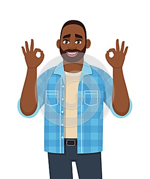 Trendy young African man showing okay, cool gesture sign. Successful black person making OK, good symbol with fingers.