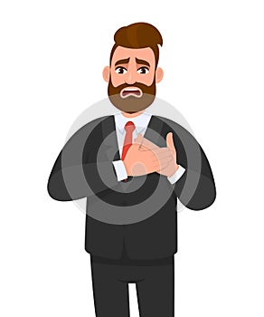 Trendy young business man having heart ache, holding hands on chest. Heart attack or stroke. Stressed person suffering chest pain