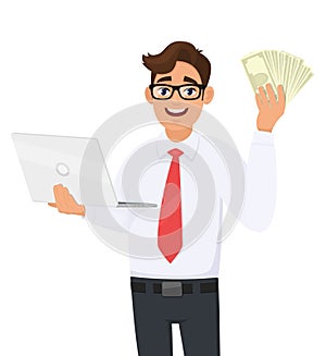 Trendy young businessman holding laptop and showing cash, money or currency notes in hand. Stylish person using computer.