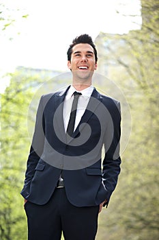 Trendy young businessman smiling outdoors