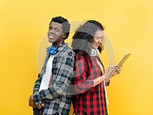 Trendy Young Couple With Headphones and Tablet On Yellow