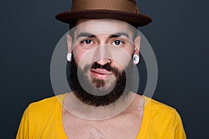 Trendy young man with beard and piercings