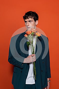 Trendy young man in blazer holding