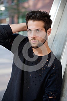 Trendy young man posing with hand in hair