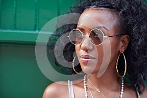 Trendy young woman in camisole and sunglasses and jewellery photo