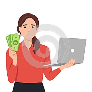 Trendy young woman holding laptop computer and showing cash, money, currency notes. Girl using digital device. Female character