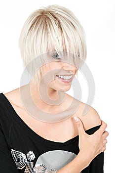 Trendy young woman with a modern blond hairstyle