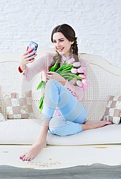 Trendy young woman posing one her phone camera