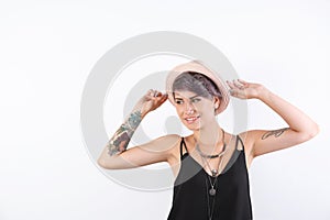 Trendy young woman with tattoos on white background